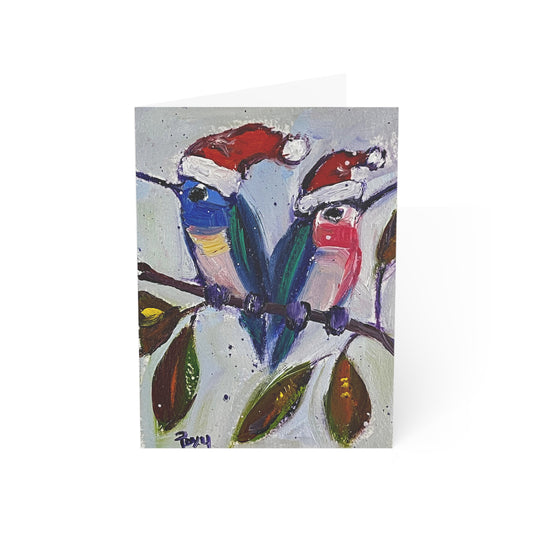 Tarjetas de felicitación dobladas con colibríes navideños en blanco por dentro